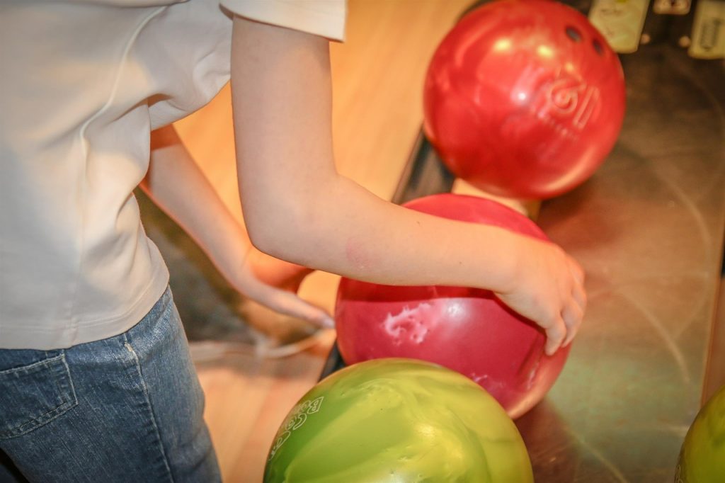 A Boy choosing a Bowling Ball - Post Picture for New bowling balls releases and Old Performers Comparison
